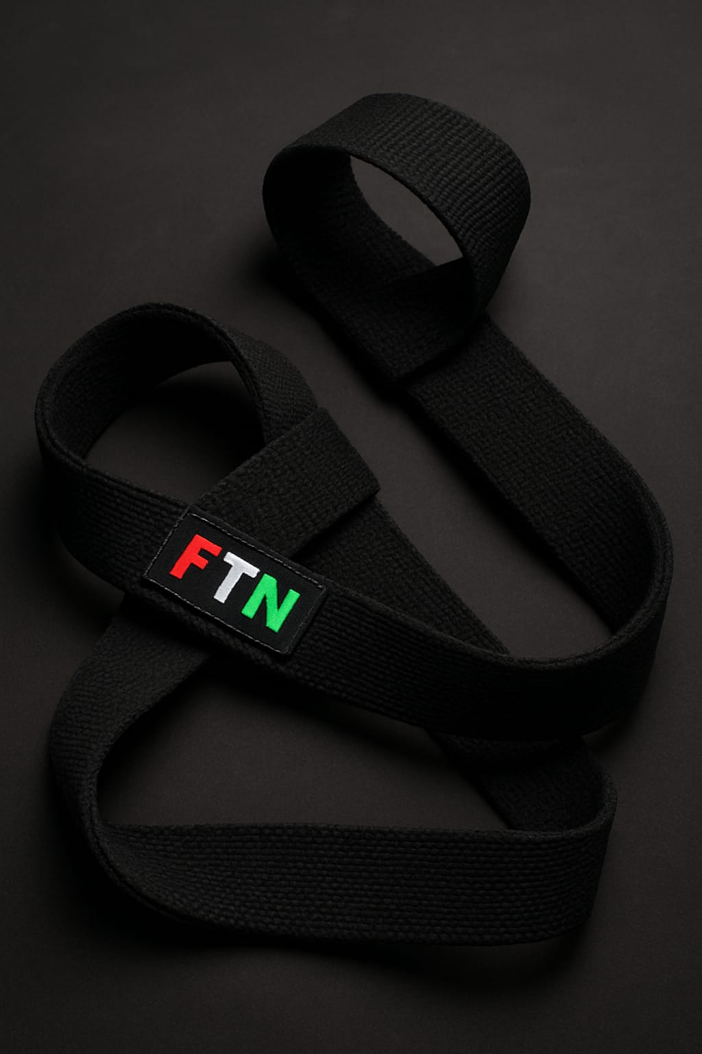 Durable lifting straps on a dark background with FTN logo — F in red, T in white, and N in green — designed to improve grip strength and lifting performance.